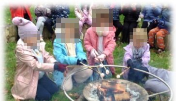 Children toasting marshmallows over the firepit